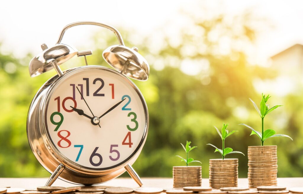 "Clock with gold coins symbolizing time and investment growth